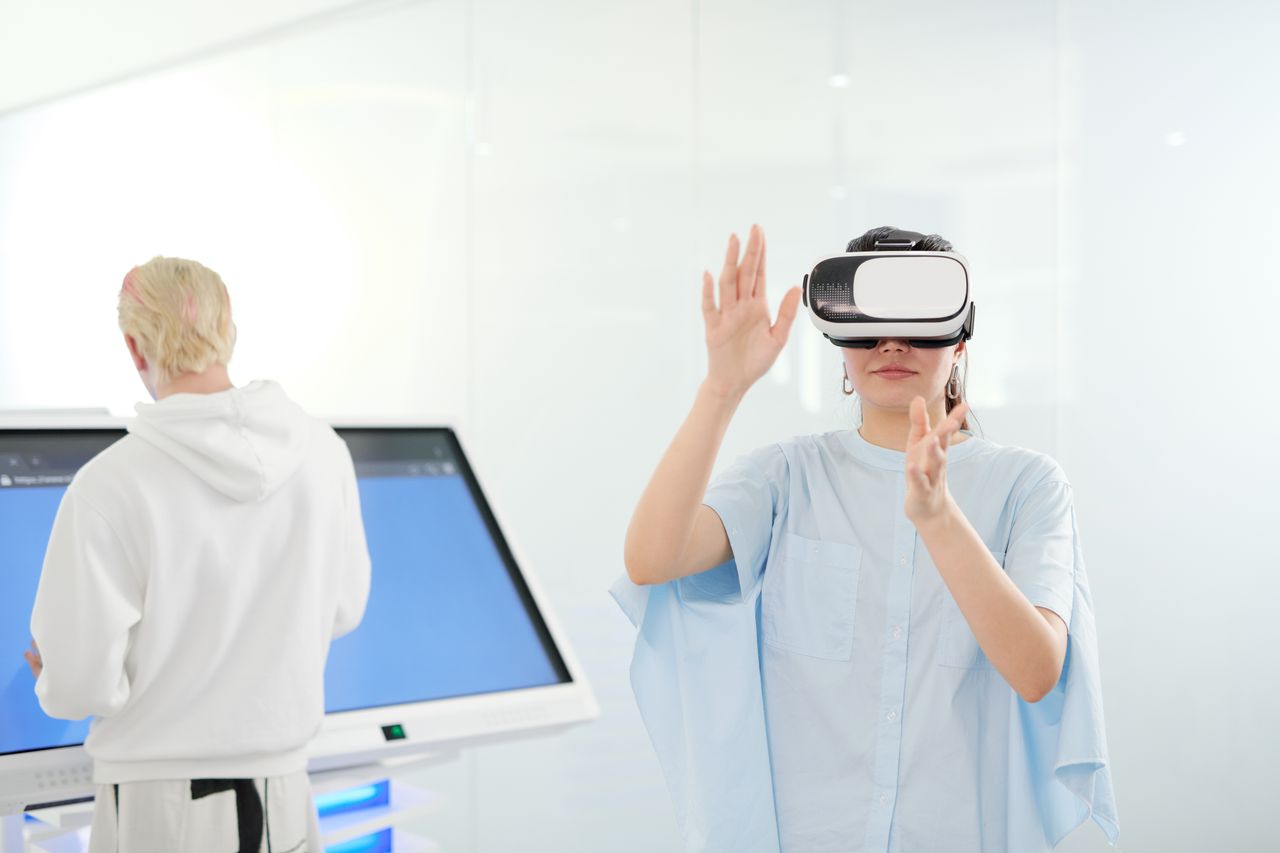 services-02 Woman exploring virtual reality with VR goggles in a modern technological environment.